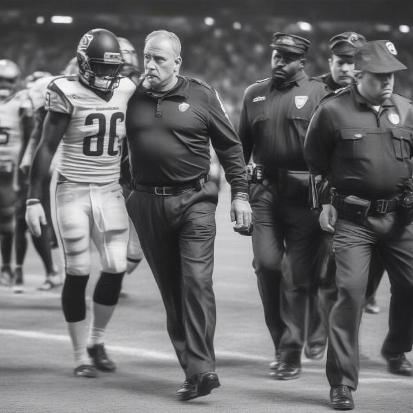 Coach being escorted off the field after a disappointing game