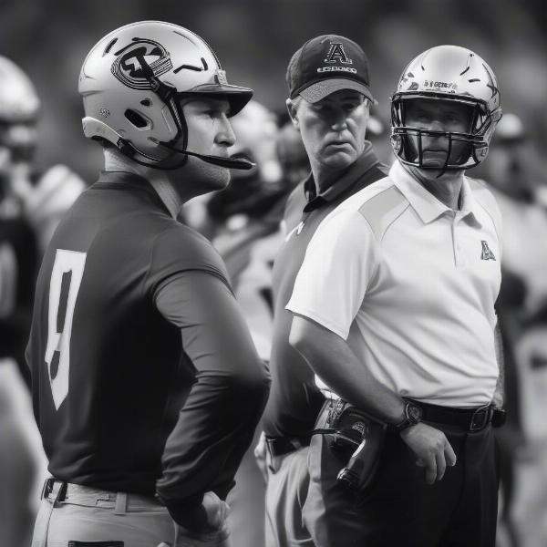 Coaches discuss strategy during Colorado-Arizona game
