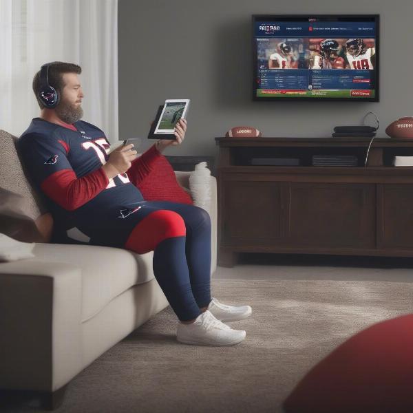 Houston Texans fan checking scores on tablet while watching the game