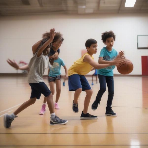 Young basketball players engaged in a monkey in the middle passing drill