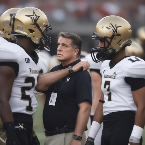 Vanderbilt Football Coach Discussing Strategy on the Sidelines